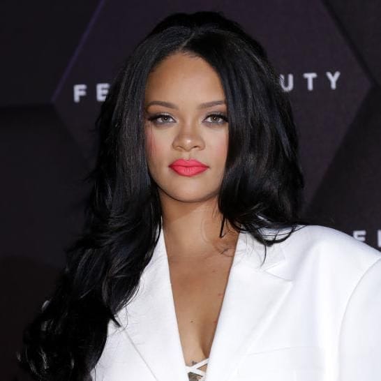 Rihanna with luminous makeup and red lipstick