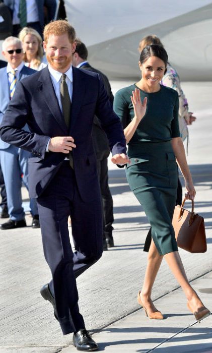 The Duke and Duchess of Sussex made a stunning landing in Dublin on Tuesday, July 10 to kick-start their two-day tour. Meghan looked as stylish as ever, wearing a fitted green shirt and skirt by one of her favorite designer's Givenchy, which she accessorized with Strathberry Mid tote in tan. She kept her hair tied up in a low bun and her makeup natural. Harry, who appeared happy and relaxed by her side, was looking dapper in a suit.
Photo: Getty Images