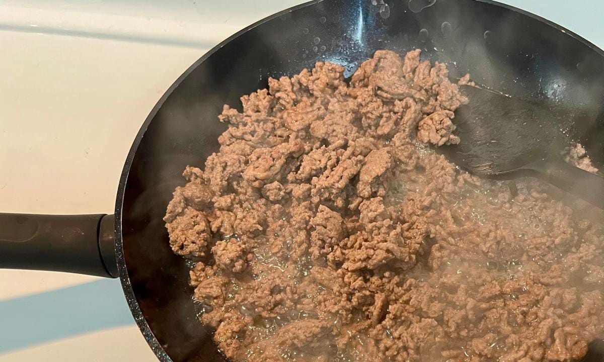 Browning ground beef in a skillet   stock photo