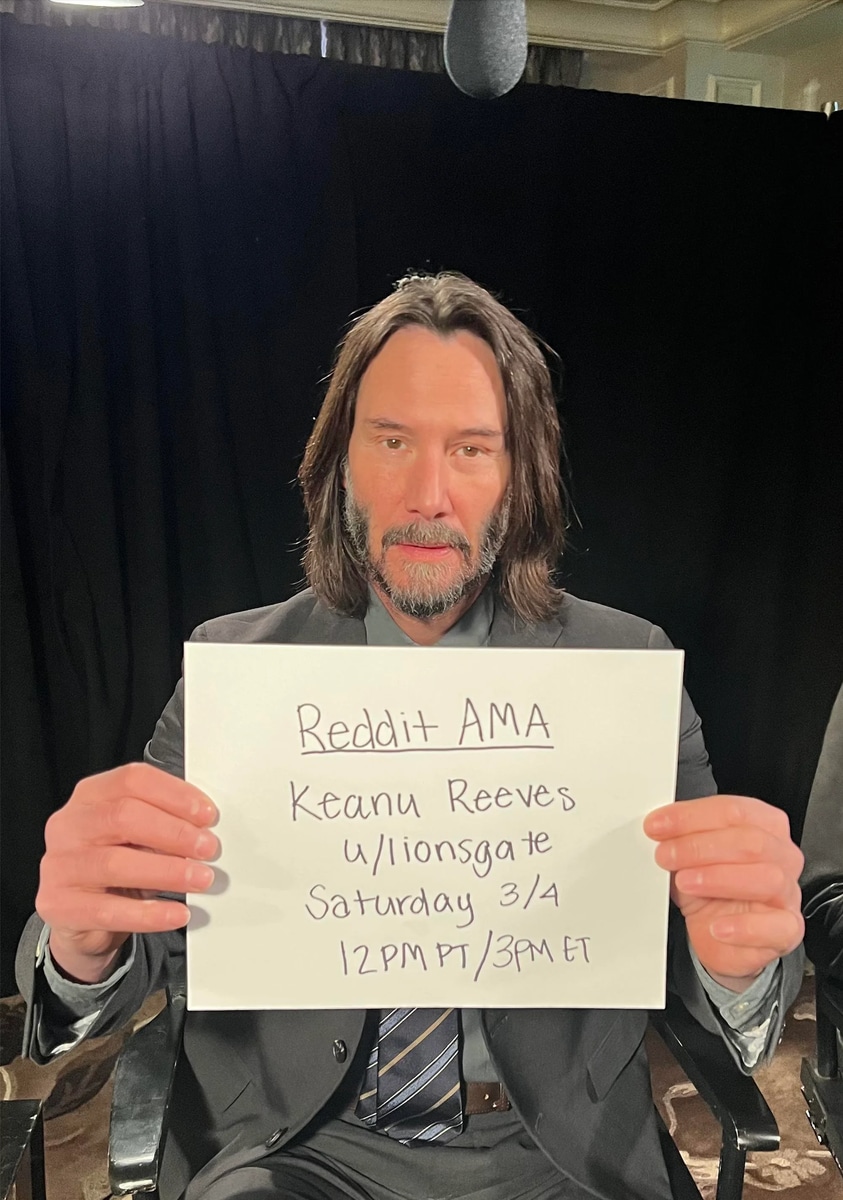 Keanu Reeves holds an AMA sign to prove his identity