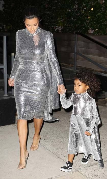 <b>September 2016</B>
Kim and her adorable little daughter had the ultimate twinning moment as they headed to dad Kanye's concert at Madison Square Garden in matching silver sequin dresses. Kim paired her dazzling, asymmetrical gown with nude stilettos, while North wore tiny hi tops.
Photo: Getty Images