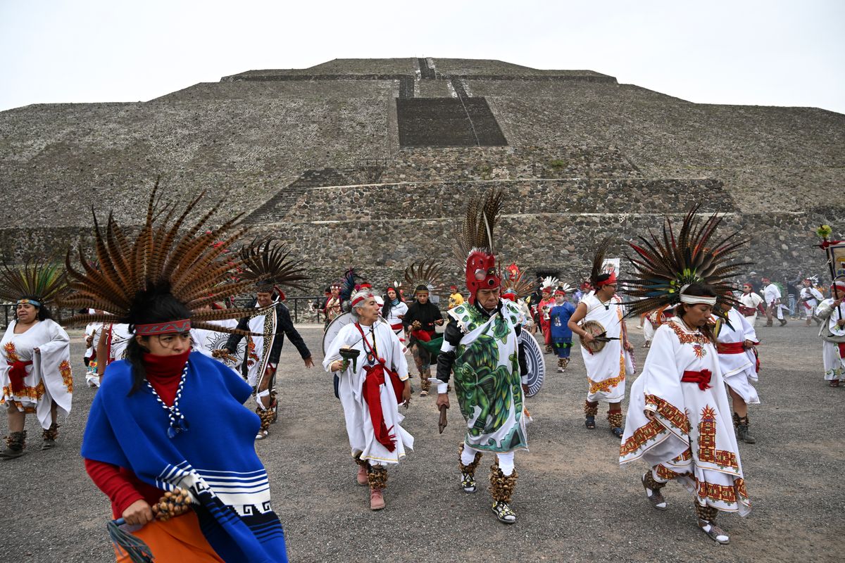 Members of indigenous communities take part in a ritual in front of the Pyramid of the Sun while celebrating the spring equinox at the Teotihuacan archaeological complex in Mexico City on March 20, 2025.