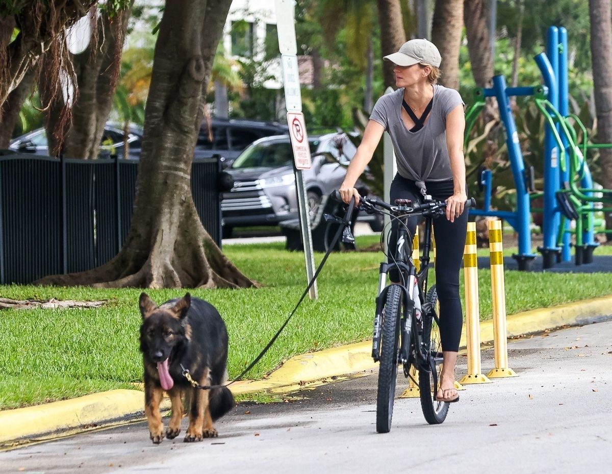 Gisele Bundchen goes for an early morning bike ride around the community with her daughter Vivian and their dogs after spending a short vacation and celebrating her birthday in Brazil surrounded by her entire family. 