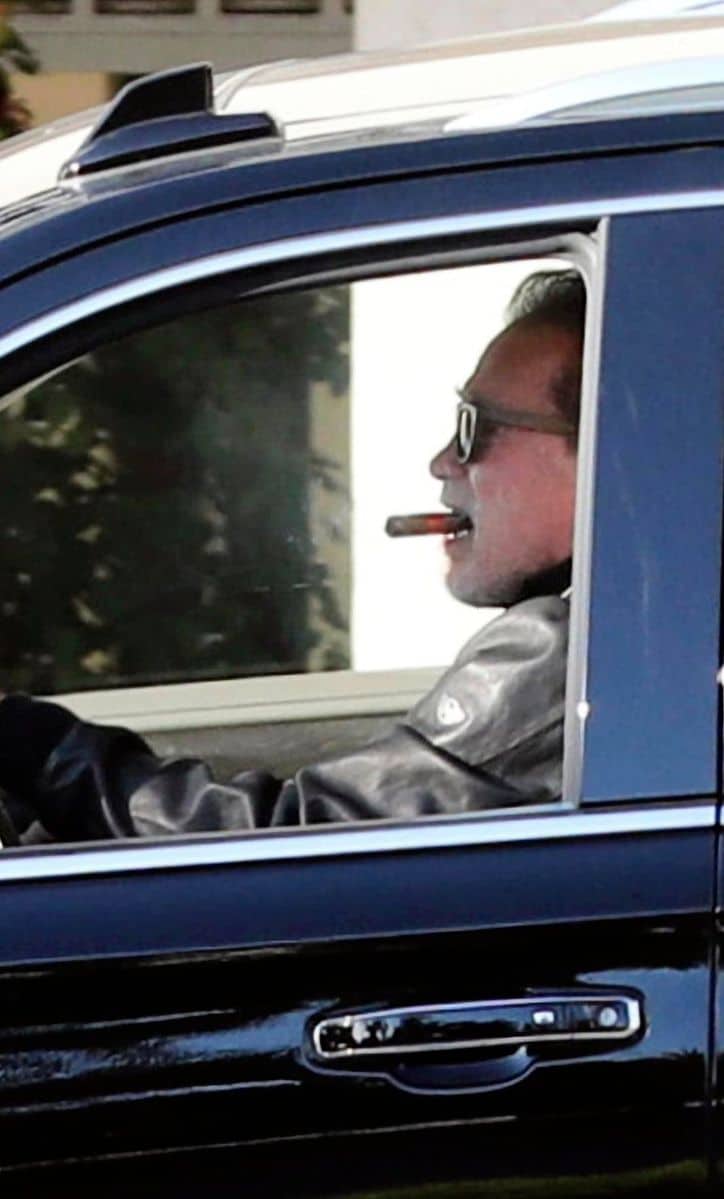 Arnold Schwarzenegger smoking a cigar in the car a few weeks after having heart surgery.