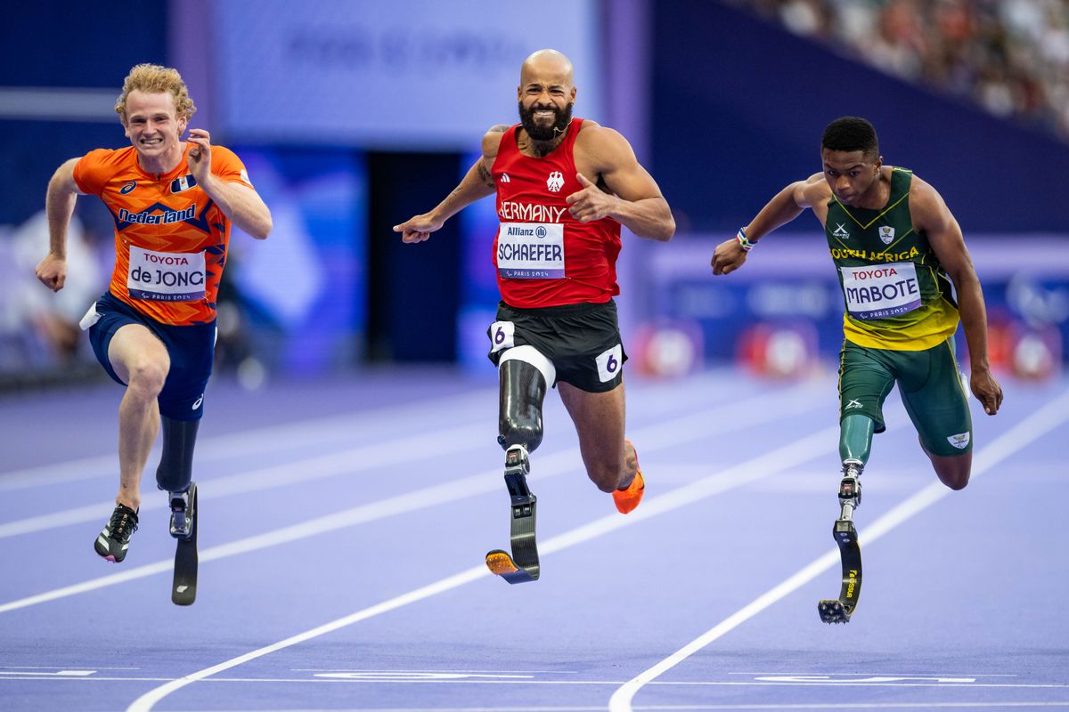 Joel de Jong of Team Netherlands, Leon Schaefer of Team Germany and Puseletso Michael Mabote of Team South Africa competes during the Men's 100m - T63