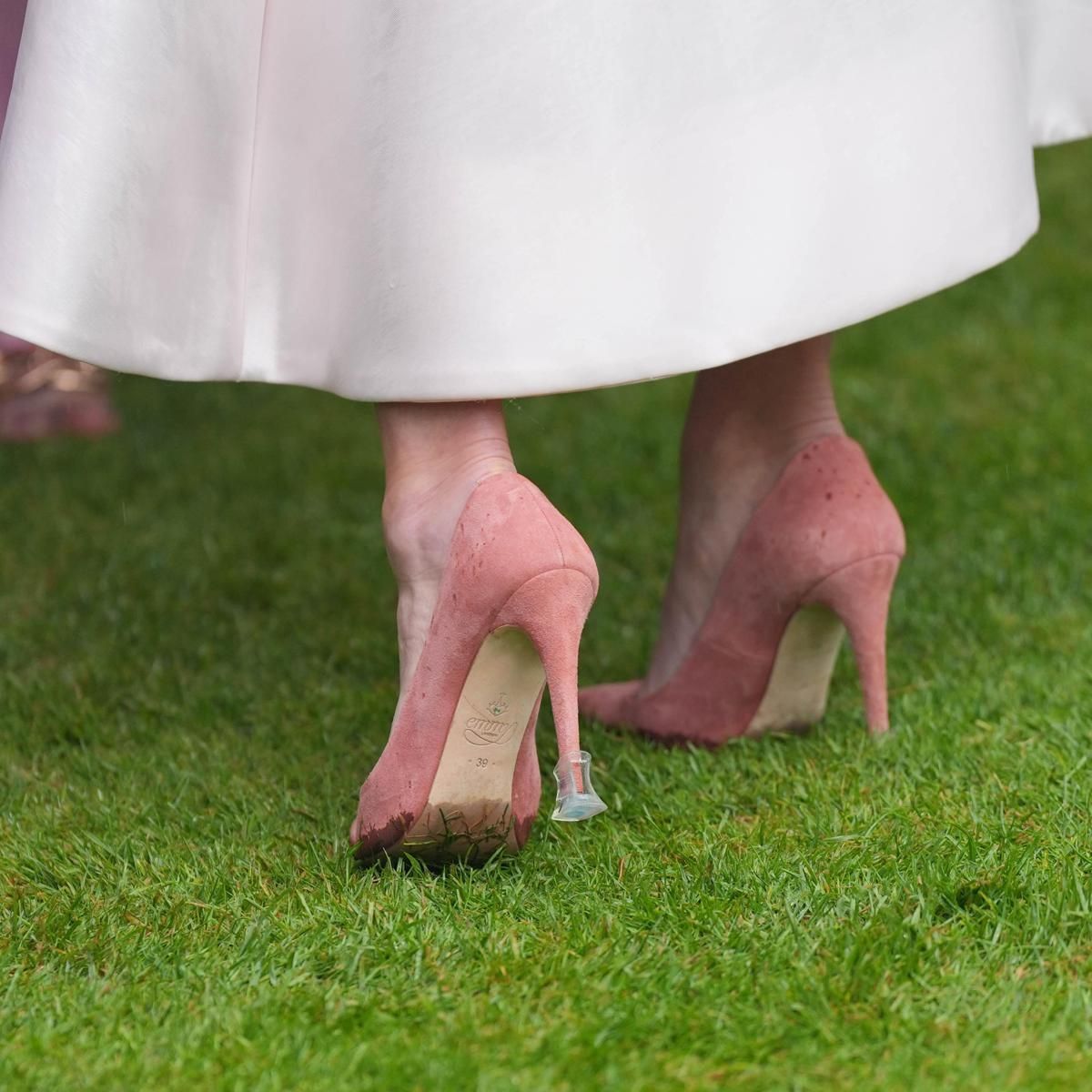 Zara prevented her suede pumps from sinking into the wet grass with clear heel stoppers.