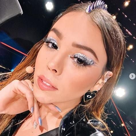 Danna Paola wears spikes in the middle parting of her luscious locks/mane