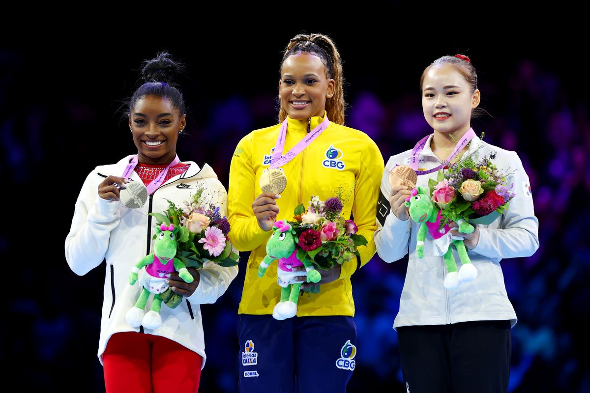 (L-R) Silver medalist Simone Biles of Team United States, gold medalist Rebeca Andrade of Team Brazil, and bronze medalist Seojeong Yeo of Team Republic of Korea pose for a photo during the medal ceremony for the Women's Vault Final on Day Eight of the 2023 Artistic Gymnastics World Championships at Antwerp Sportpaleis on October 07, 2023, in Antwerp, Belgium. 