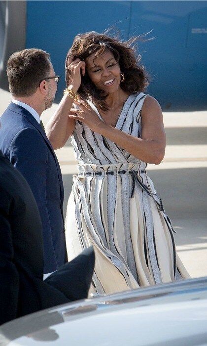 FLOTUS' hair was no match for the wind in Spain. Michelle fixed herself as she made her way to the car.
<br>
Photo: Pablo Cuadra/Getty Images