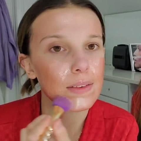 Millie Bobby Brown putting on a mask