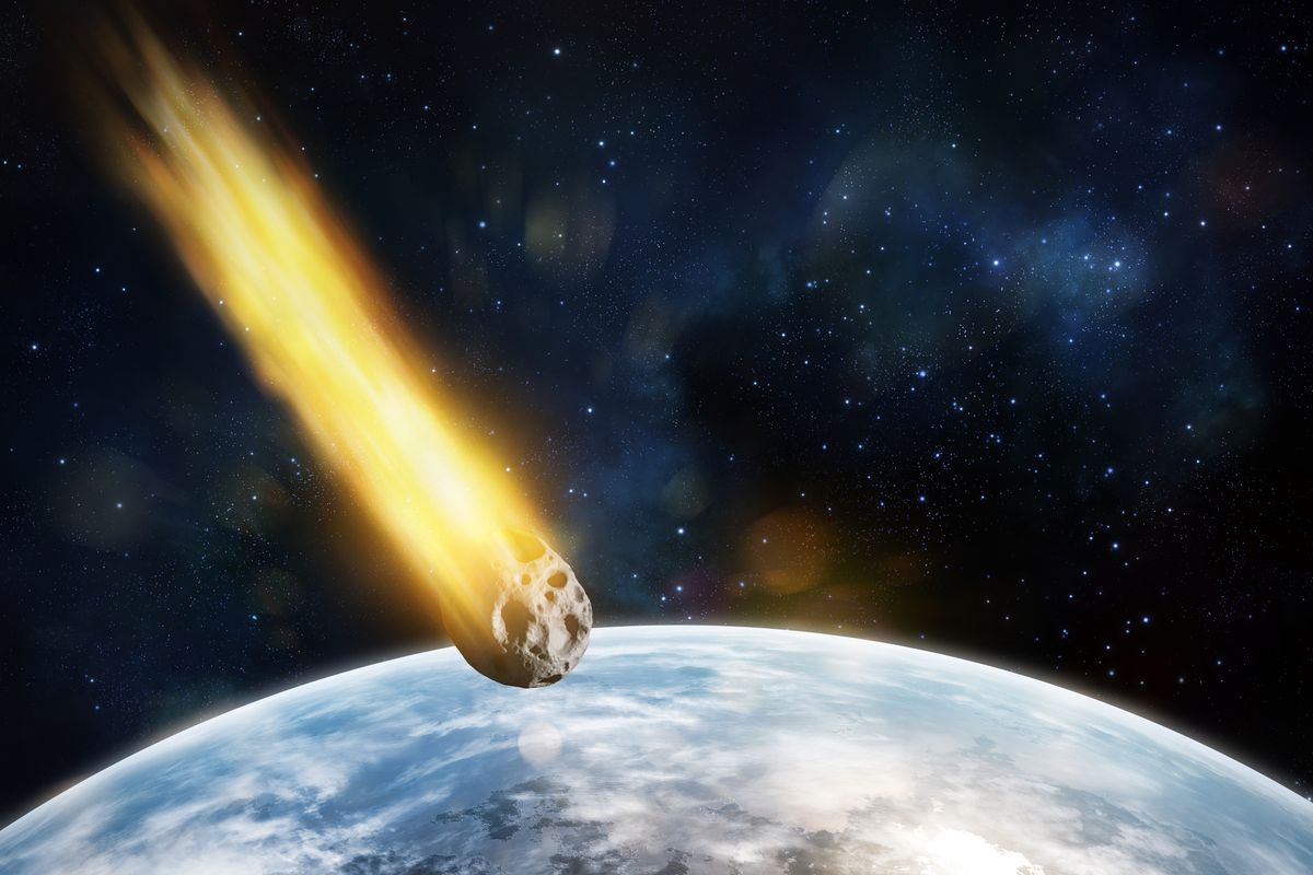 Digital illustration of asteroid entering atmosphere of a blue planet.