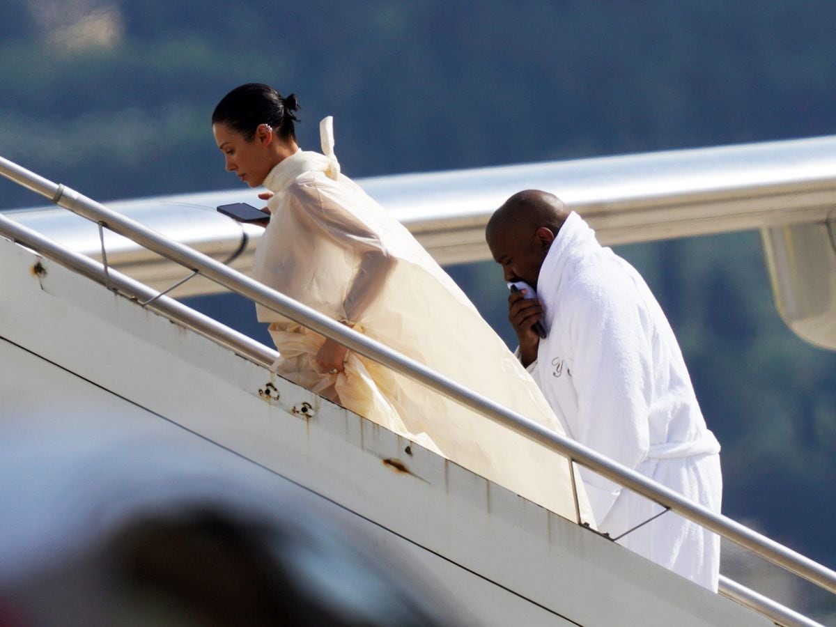 Kanye West is seen leaving Florence with his wife Bianca, sporting a bathrobe 