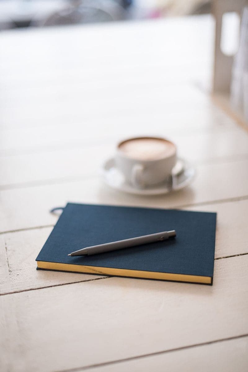 Notebook with coffee cup