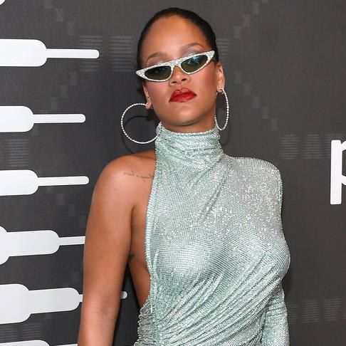 Rihanna with sunglasses and an asymmetric dress