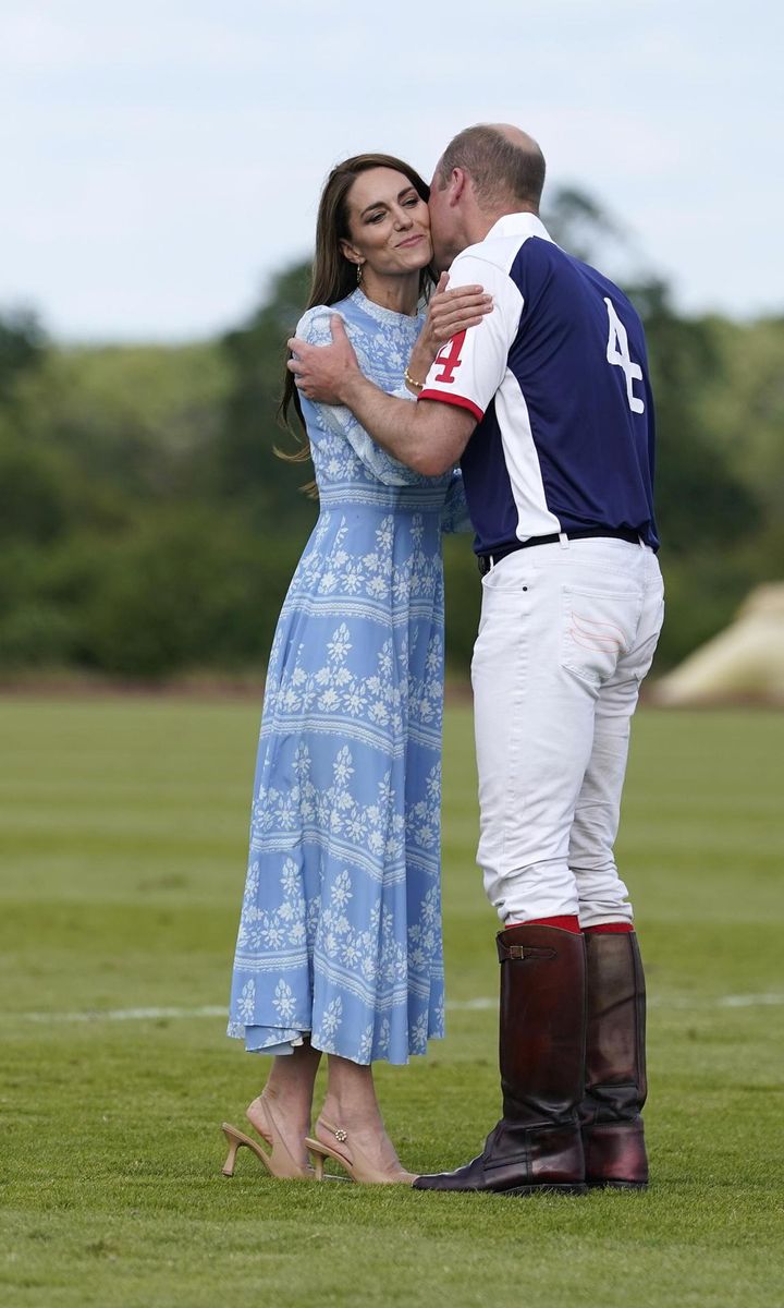 Catherine congratulated William with kisses on the cheek.