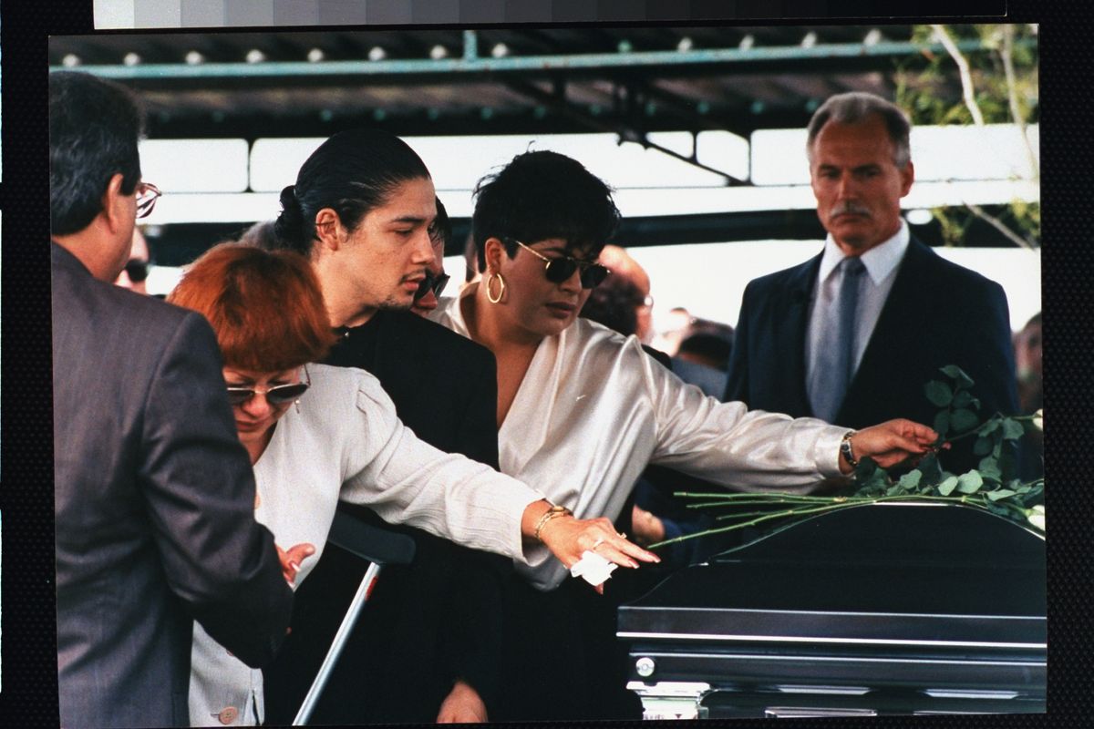 Familia de la cantante tejana Selena que fue asesinada por el ex presidente de su club de fans. Yolanda Saldívar: madre Marcela Quintanilla (2L), esposo Chris Pérez (3L) y hermana Suzette (2R) depositando rosas sobre el ataúd en su funeral. (Foto de Barbara Laing/Getty Images)