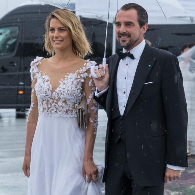Prince Nikolaos and Princess Tatiana walk in the rain