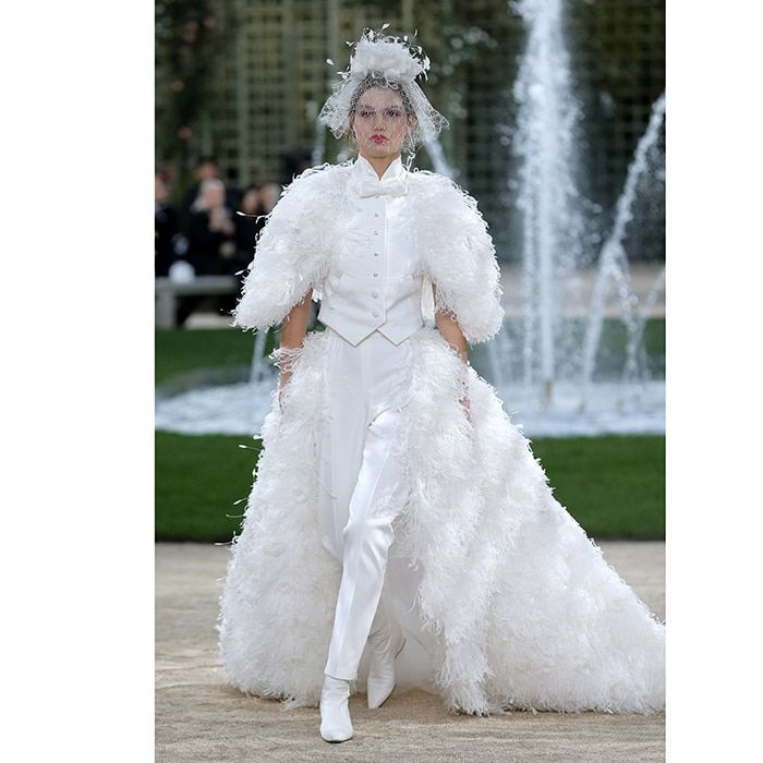 <B>CHANEL</B>
Chanel designer Karl Lagerfeld seemed to be influenced by his own signature sartorial style with a masculine finale look of pants, vest and bow tie. Adding an additional touch of bridal flair are the creation's tulle veil and feather skirt and jacket.
Photo: WENN
