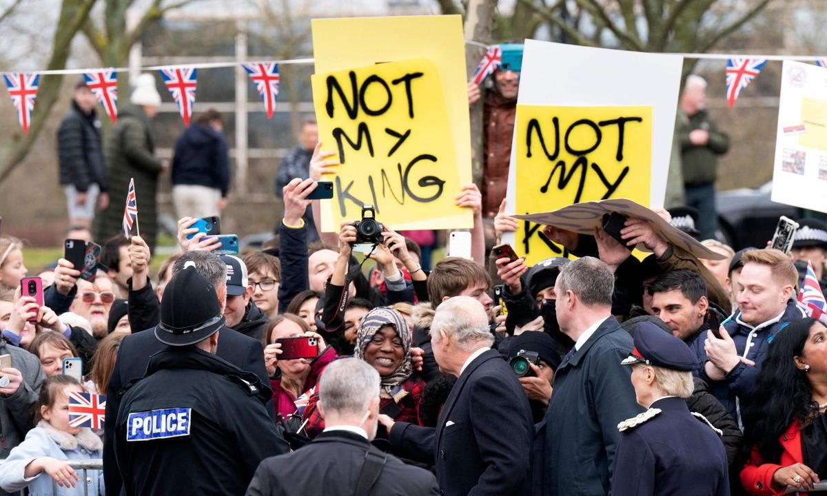 Individuals held up signs that read "Not My King"