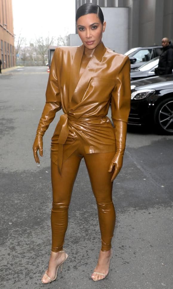 Kim Kardashian wearing a latex outfit from Balmain in mustard yellow