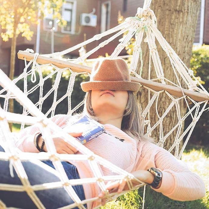 Woman laying in hammock taking a nap.