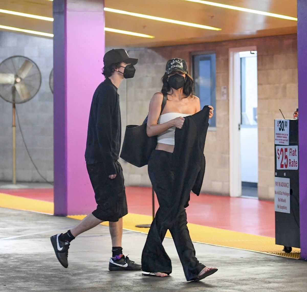 Still going strong! Kylie Jenner and actor Timothée Chalamet keep a low profile with baseball caps and face masks on as they are spotted heading to the Grauman's Chinese Theatre to watch a movie on romantic date night in Los Angeles. 