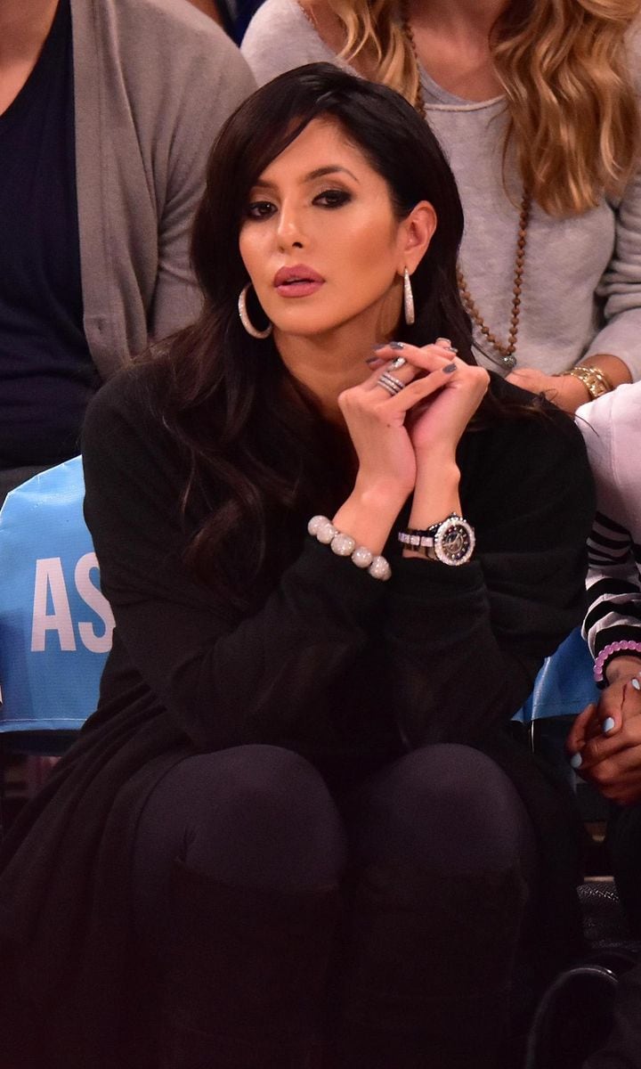 Kobe Bryant's wife watching a basketball game with serious face