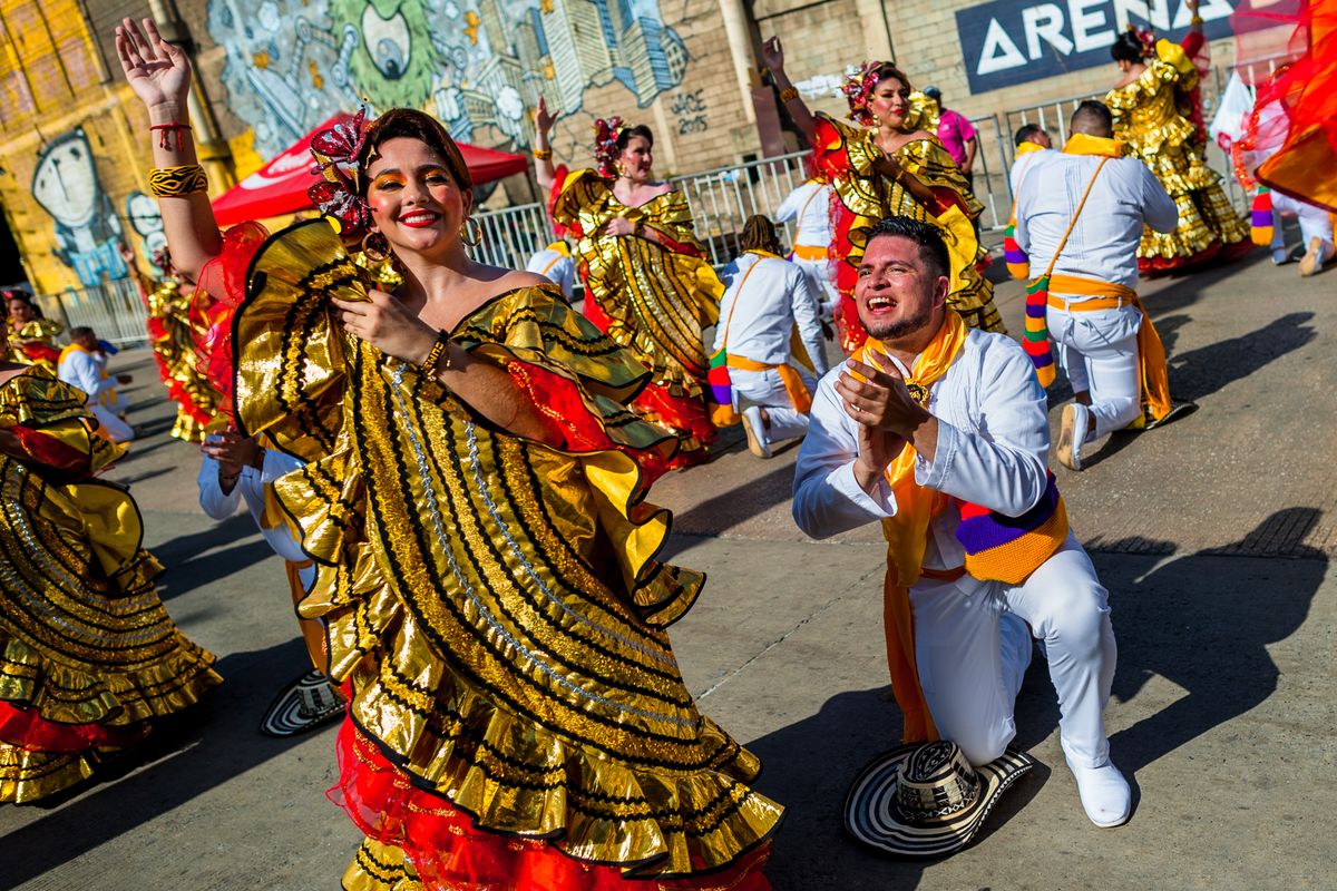 BARRANQUILLA, COLOMBIA - FEBRUARY 11: Colombian couples, wearing traditional cumbia outfits, dance the cumbia during the Gran Parada, the traditional parade of the Carnival on February 11, 2024 in Barranquilla, Colombia. Barranquilla's Carnival is a tradition created by locals at the end of the 19th century as a response and parody of the celebrations held by European immigrants and the aristocracy. Thousands of dancers and dance groups (comparsas), accompanied by musicians, sound systems, and decorated floats, march along VÃ­a 40. It was declared a Masterpiece of the Oral and Intangible Heritage of Humanity by UNESCO in 2003. (Photo by Jan Sochor/Getty Images)