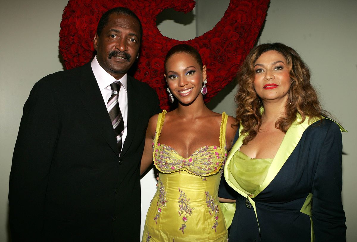 Singer Beyonce Knowles (C) poses with her father and manager, Matthew Knowles, and her mother, Tina Knowles, at the "Beyonce: Beyond the Red Carpet auction presented by Beyonce and her mother, Tina Knowles, along with the House of Dereon to benefit the VH1 Save The Music Foundation June 23, 2005, in New York City. The exhibition will showcase 18-24 costumes worn by Beyonce, chronicling her film, television, and video appearances.  (Photo by Frank Micelotta/Getty Images)