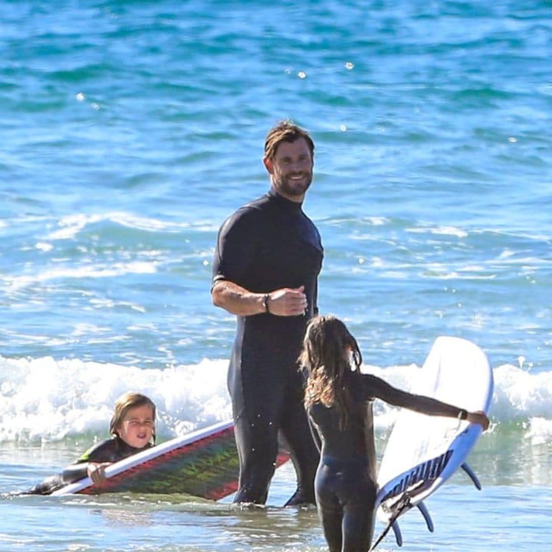 Chris Hemsworth showed off his toned muscles while surfing with his kids