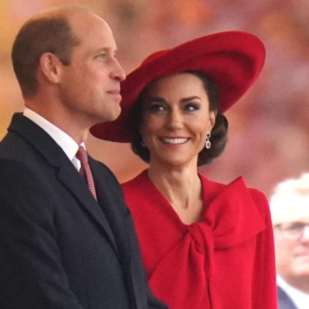 Resplendent in red! The Princess of Wales teams festive bow coat with cape