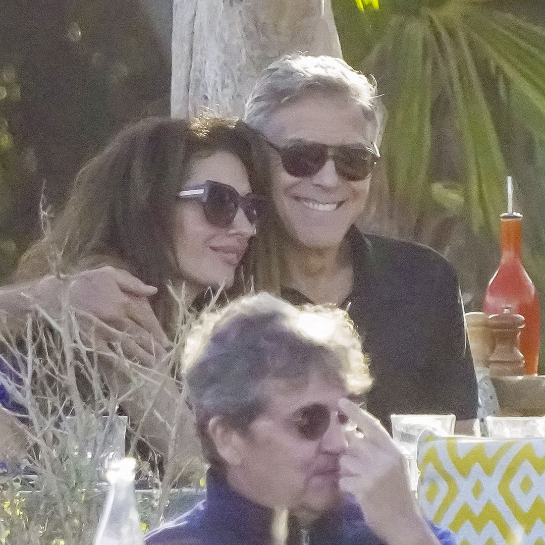 George Clooney has his arm around his wife Amal while out to lunch in Saint-Tropez