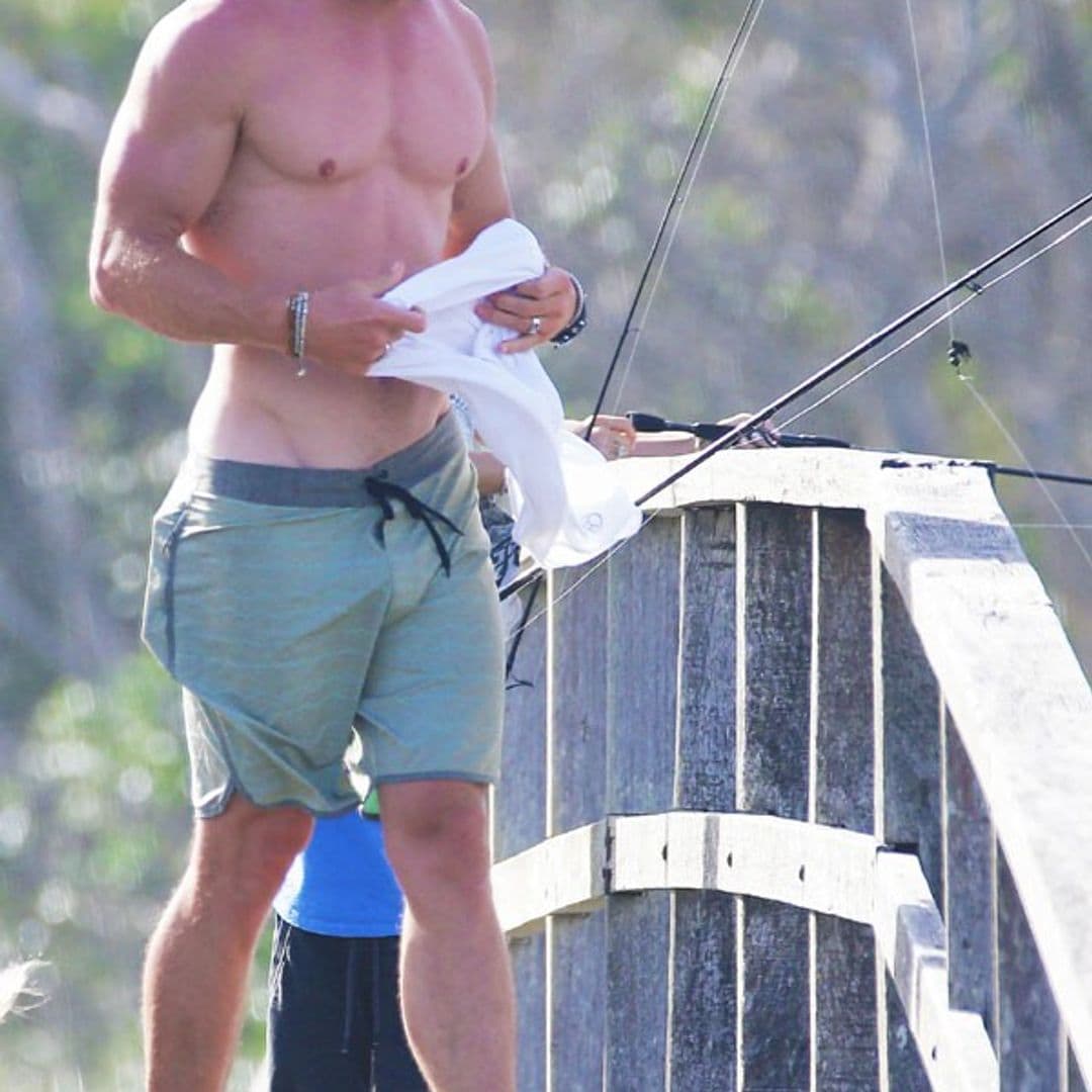 Chris Hemsworth shows off his incredible physique on family fishing trip