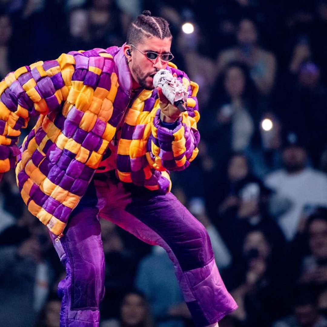 Enthusiastic Bad Bunny fan receives a kiss from the singer as she gets escorted off stage