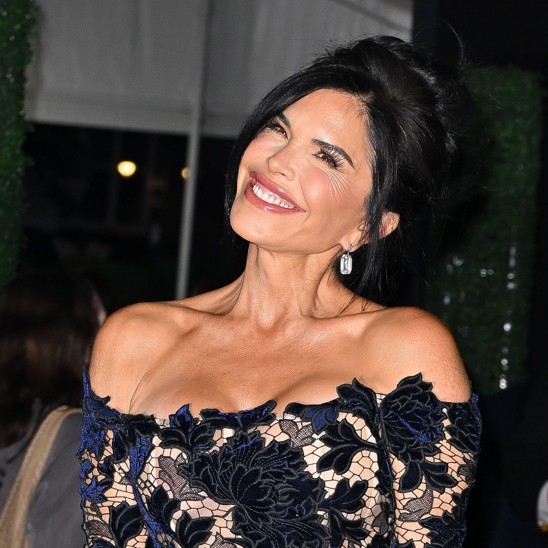 Lauren Sanchez poses in dramatic cape dress and pearl earrings at the Starlight Ball