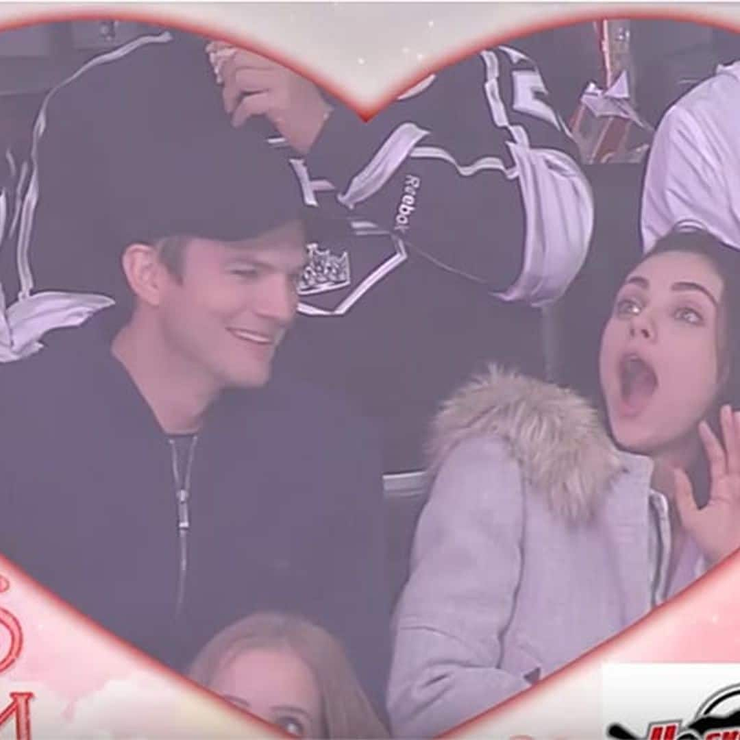 Ashton Kutcher goes in for a passionate Kiss Cam smooch – watch Mila Kunis' hilarious reaction!