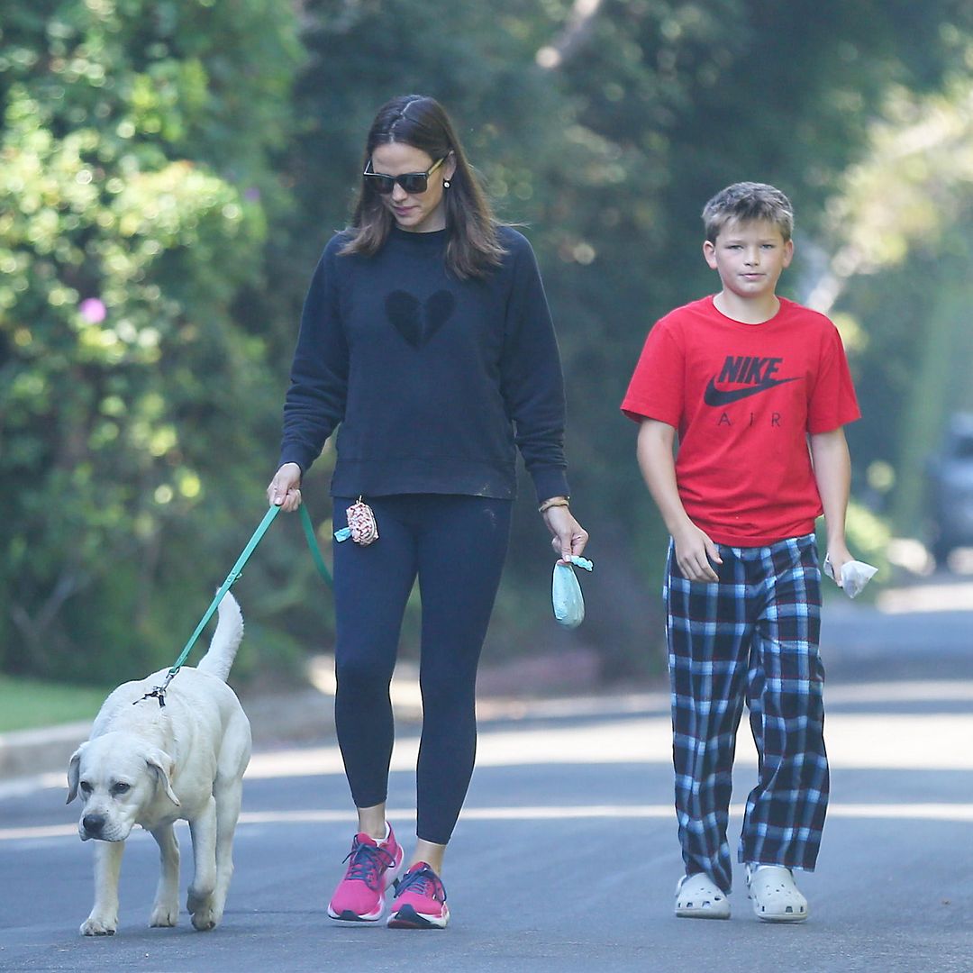 Jennifer Garner kisses Samuel Affleck while enjoying a relaxing walk with the family dog