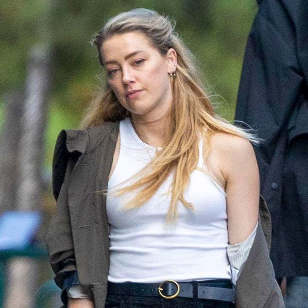 Amber Heard uses a cane while spending time with her lookalike sister