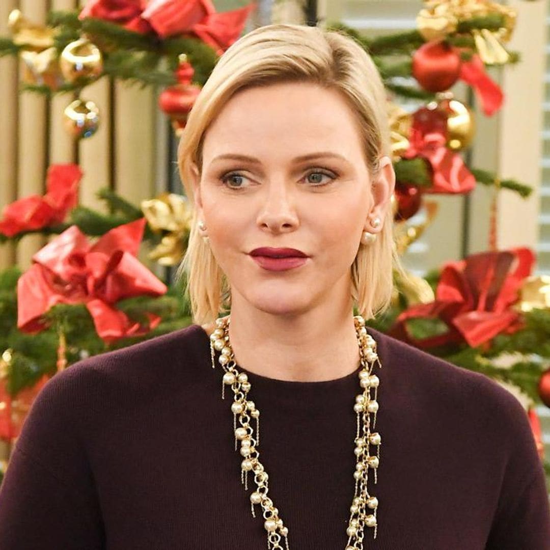 Princess Charlene wears gold and pearl statement necklace as she hands out Christmas gifts in Monaco