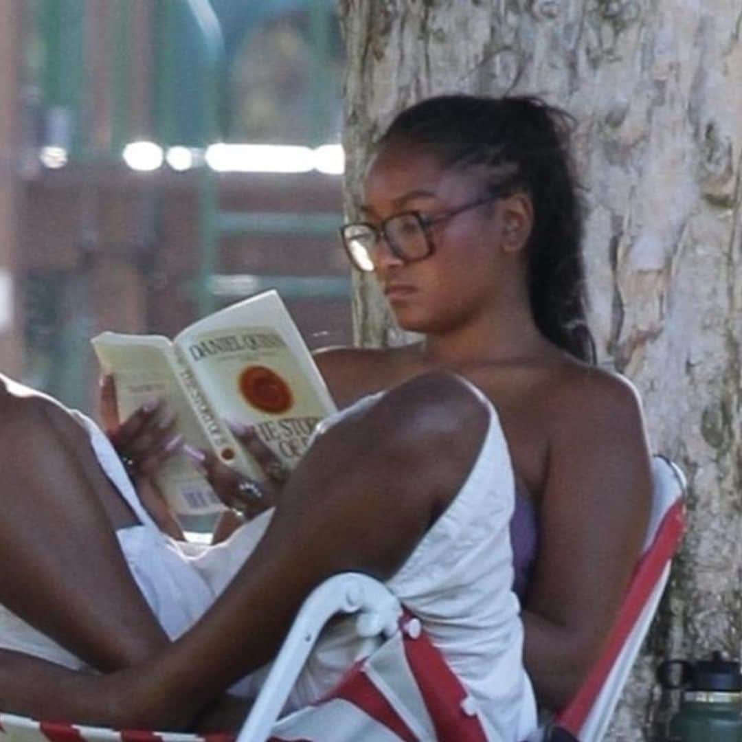 Sasha Obama relaxes under a tree while reading a philosophical novel