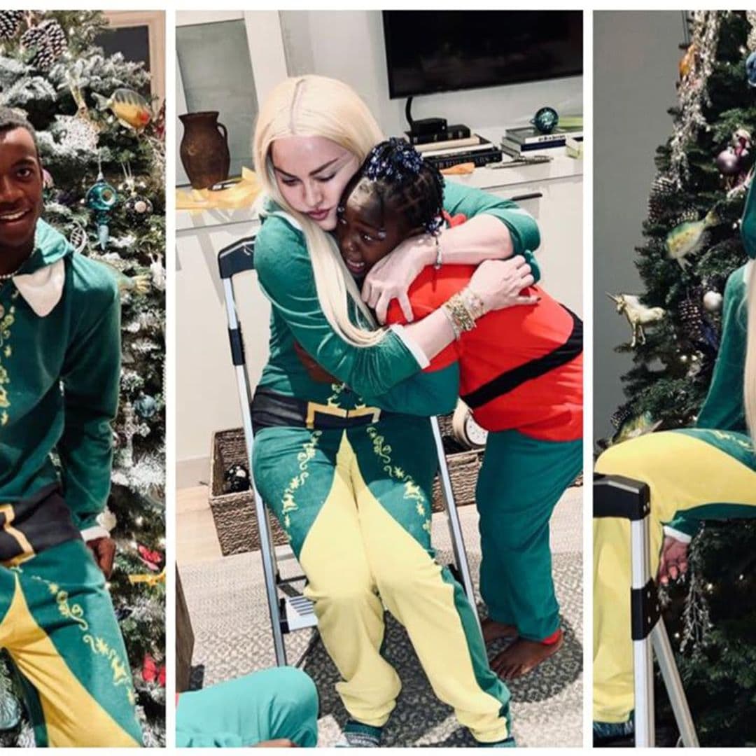 Madonna, her boyfriend, and some of her kids gather around the Christmas tree in festive pajamas