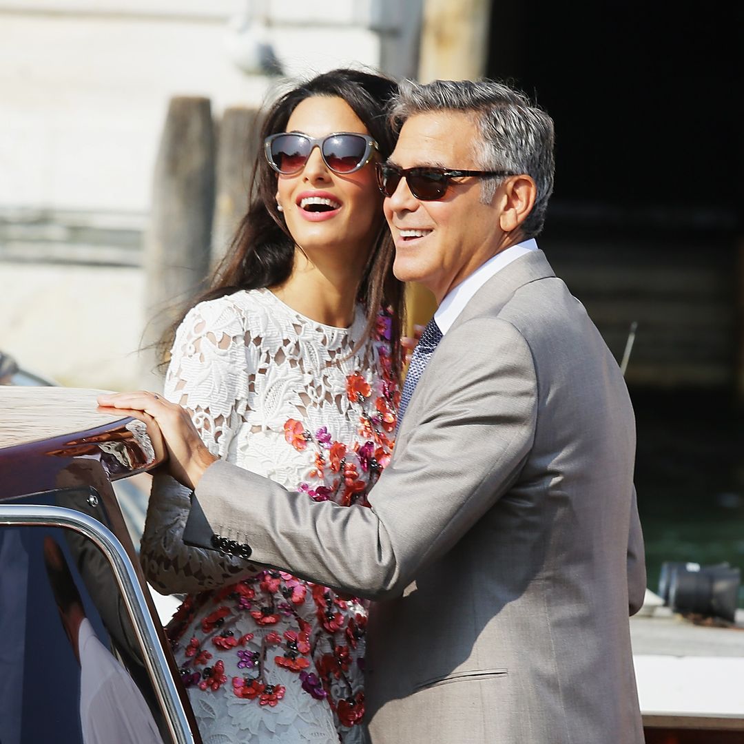 George and Amal Clooney share a romantic kiss while dining in Italy