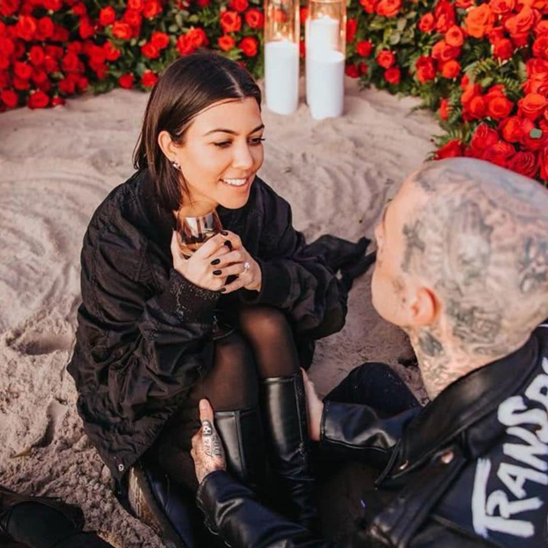 Kourtney Kardashian looks happier than ever as she lays on rose petals and shows off engagement ring