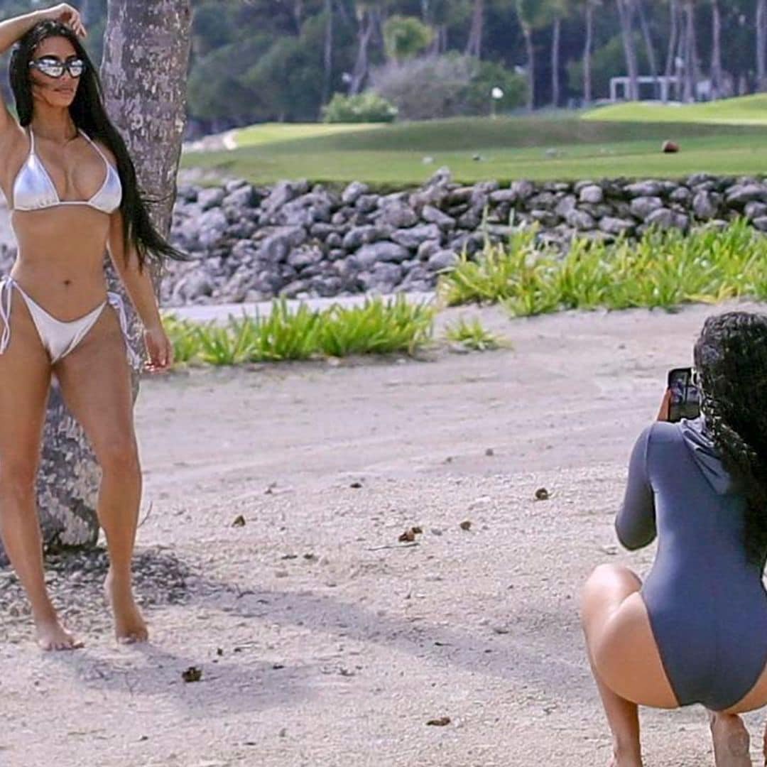 Kim Kardashian spotted while snapping stills in a shiny silver SKIMS bikini