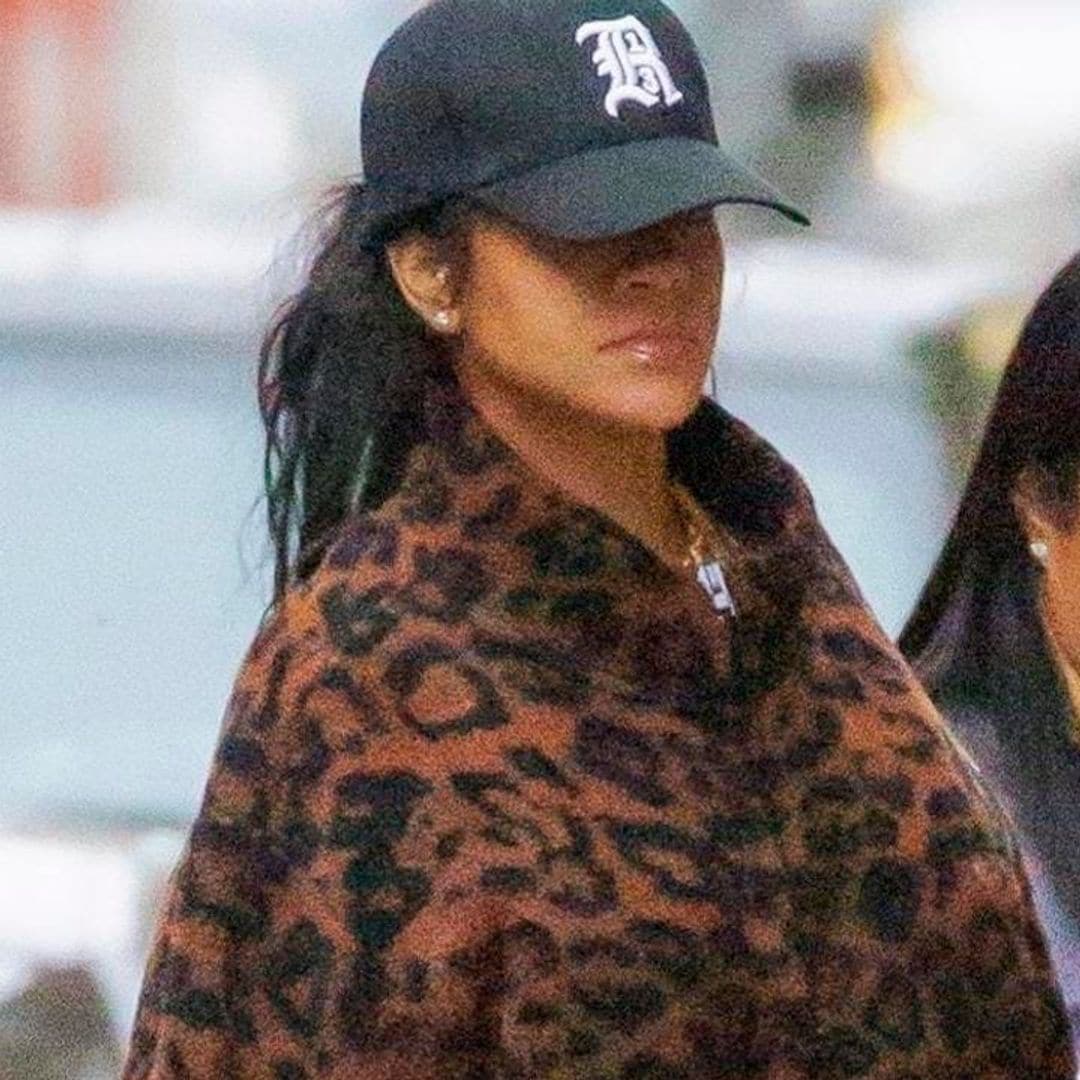 Rihanna shows off her growing baby bump in leopard print coat