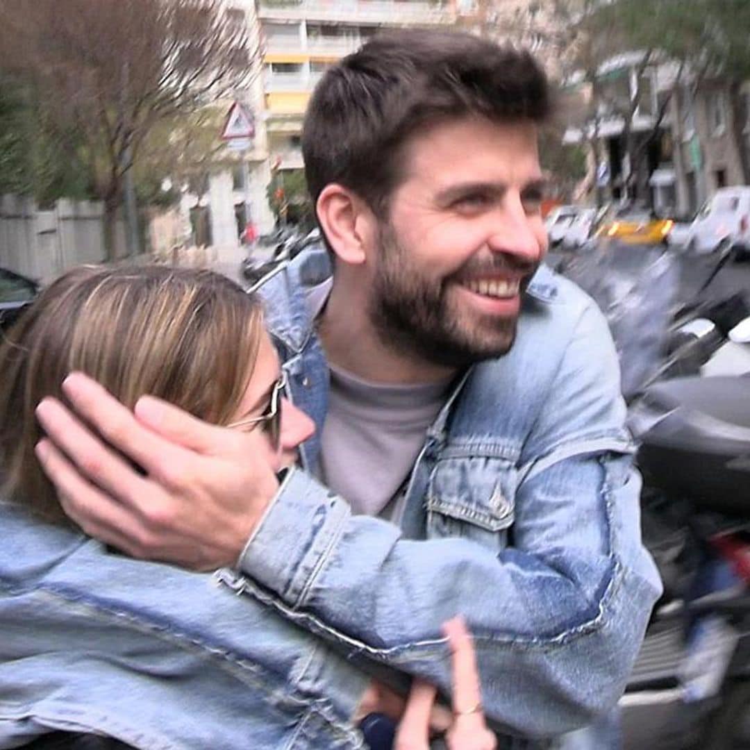 Gerard Piqué and Clara Chia laugh out loud after she hits herself with an advertising sign trying to hide from a paparazzi