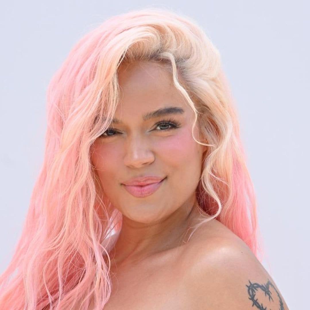 Karol G stuns in an off-the-shoulder gown and ombré pink hair at Jacquemus’ fashion show