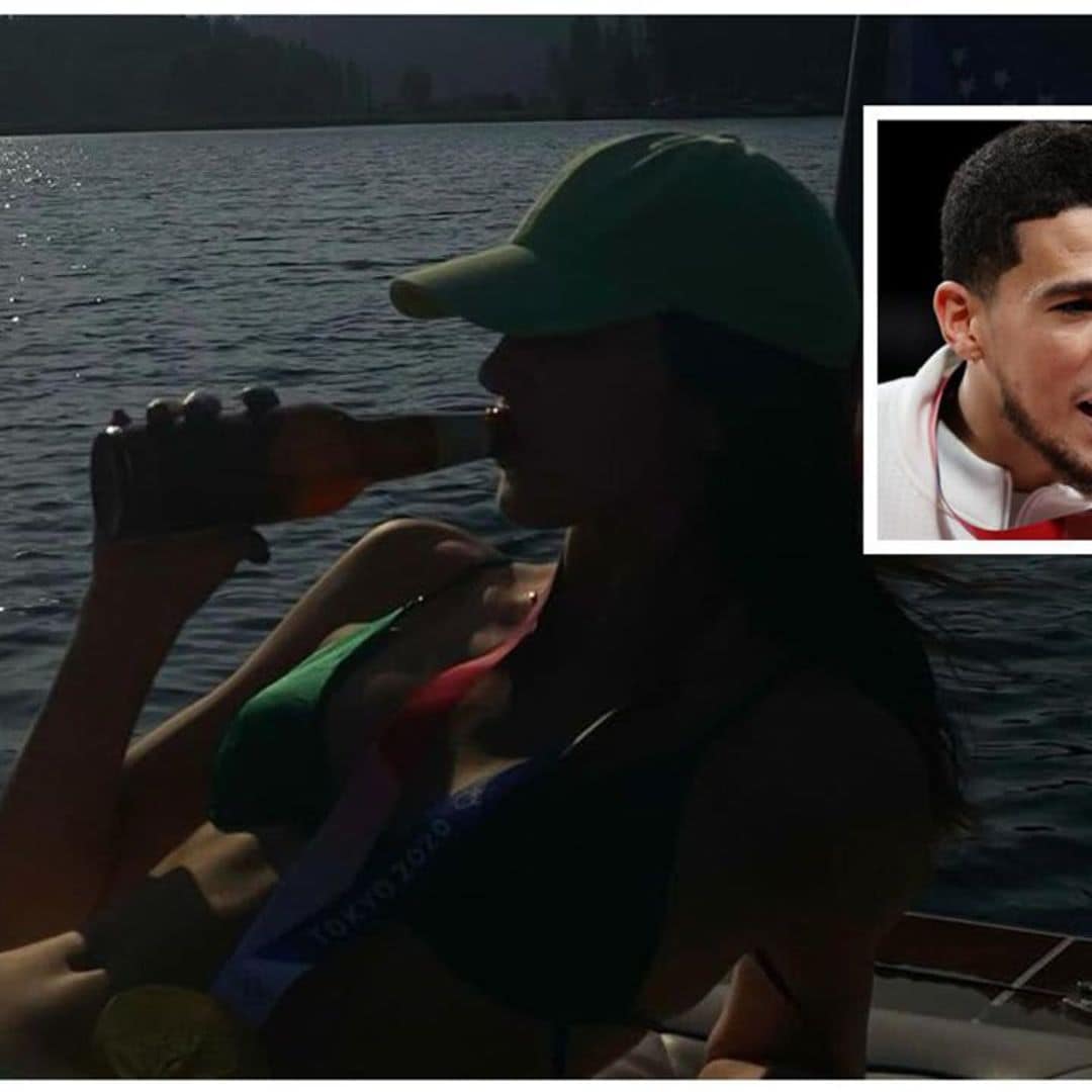 Kendall Jenner poses with Devin Booker’s Olympic gold medal and a bottle of beer while on a lake date