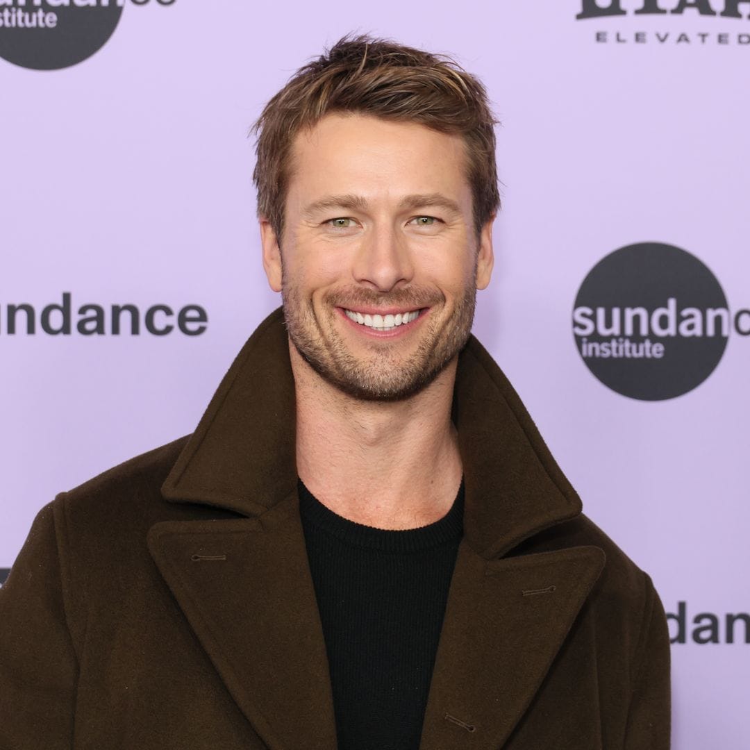 Glen Powell shows off huge biceps while posing with adorable puppy