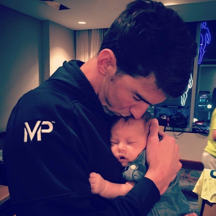 Michael Phelps cheered on by son Boomer and 'proud' family as he makes ...